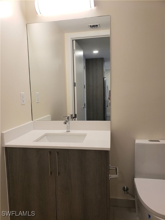 bathroom featuring vanity and toilet