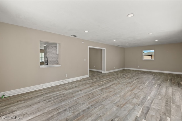 unfurnished room with light wood-type flooring