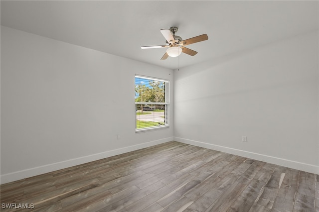 empty room with hardwood / wood-style floors and ceiling fan