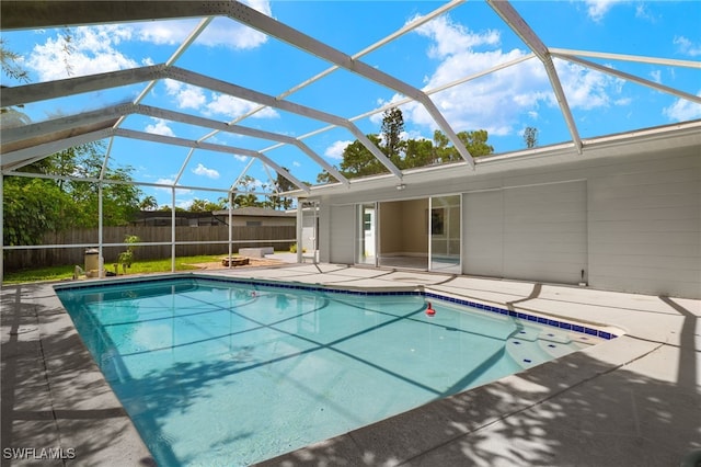 view of swimming pool featuring a patio and a lanai