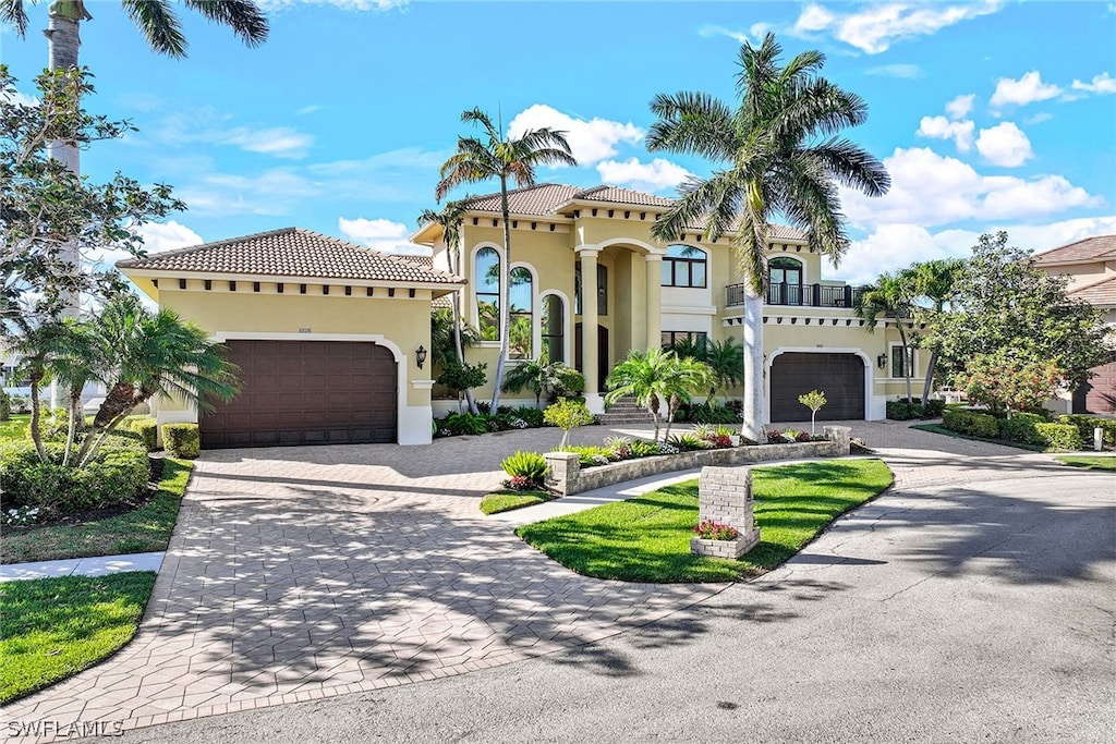 mediterranean / spanish home with a garage