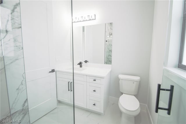 bathroom featuring vanity, tile floors, and toilet