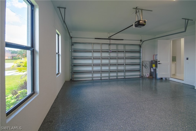 garage with secured water heater and a garage door opener