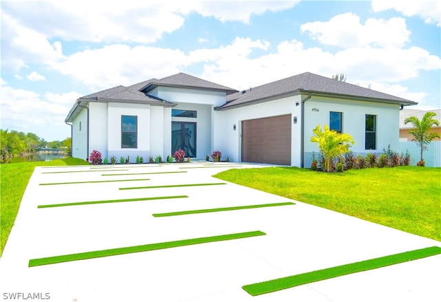 prairie-style home with a garage and a front yard