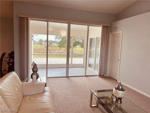 carpeted living room with lofted ceiling