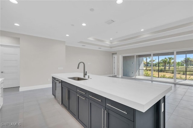 kitchen with baseboards, light countertops, a sink, and recessed lighting