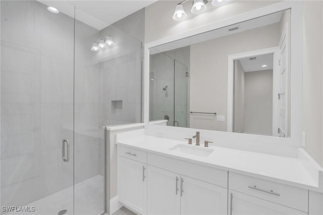 full bathroom with a shower stall and vanity