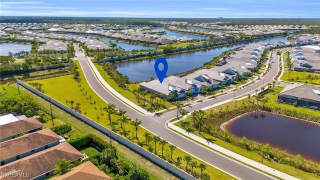 birds eye view of property with a water view and a residential view