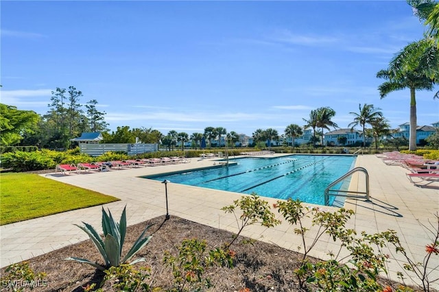 community pool featuring a patio area and a yard