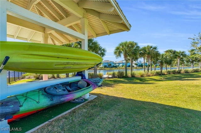 exterior space featuring a water view and a lawn