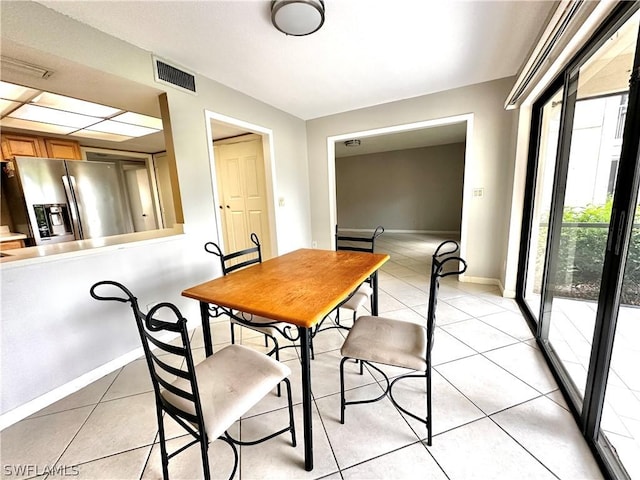 dining room with light tile patterned flooring