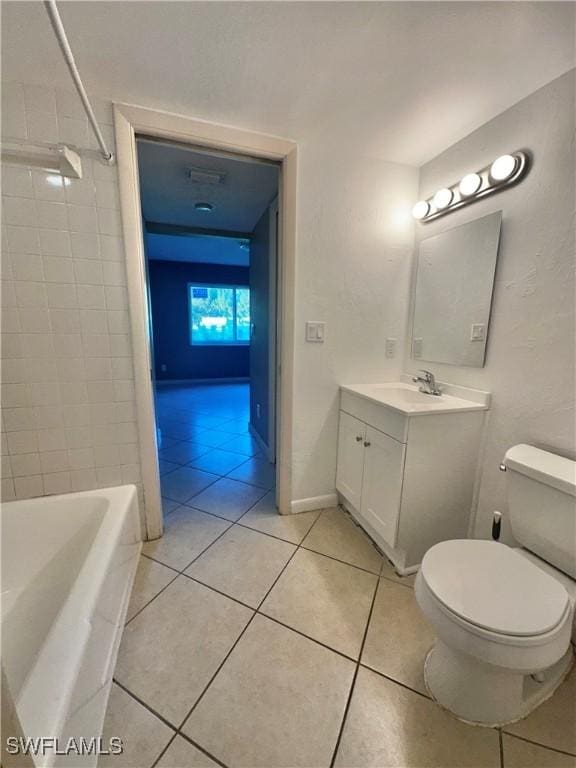 full bathroom featuring tile patterned flooring, vanity, toilet, and tiled shower / bath combo