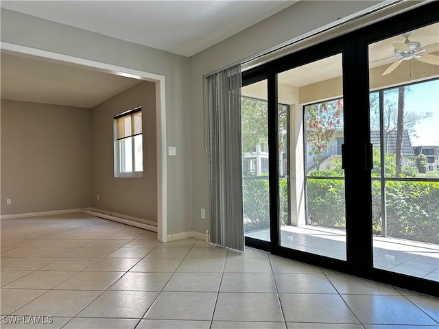 doorway to outside with tile patterned floors and baseboards