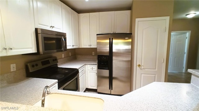 kitchen with white cabinetry, sink, and appliances with stainless steel finishes