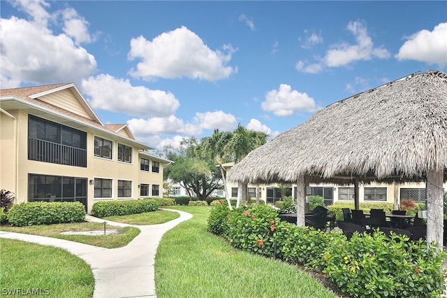 surrounding community with a gazebo and a yard