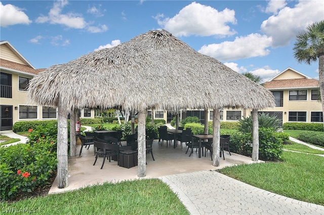 view of property's community with a gazebo, a yard, and a patio