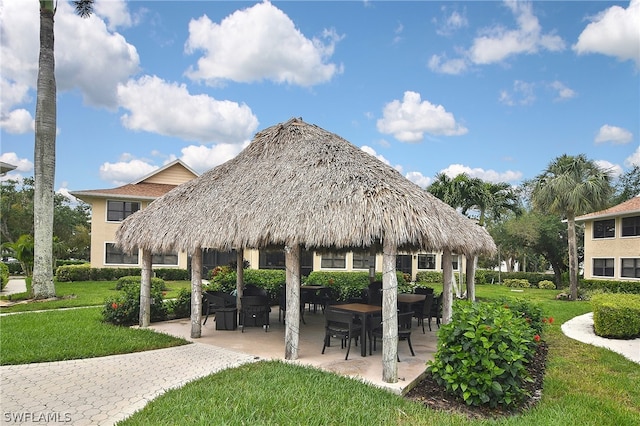 view of community with a gazebo, a patio area, and a lawn