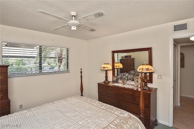 bedroom with carpet flooring, a textured ceiling, and ceiling fan