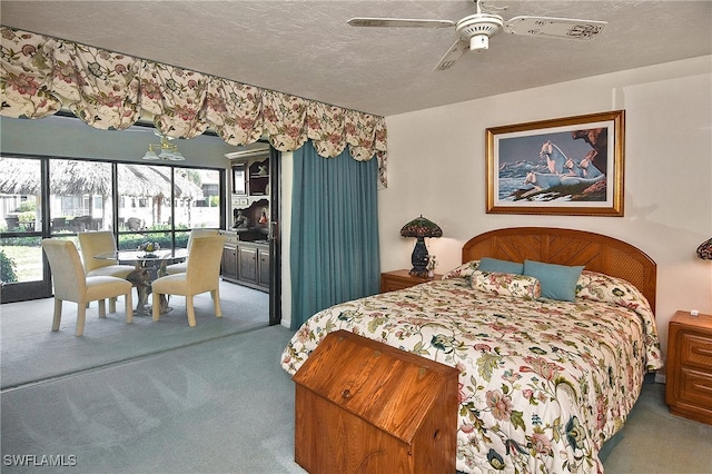 carpeted bedroom with a textured ceiling and ceiling fan