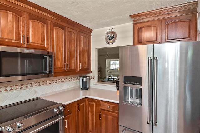 kitchen with a textured ceiling, backsplash, and stainless steel appliances