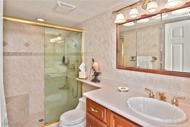 bathroom featuring toilet, an enclosed shower, and tile walls