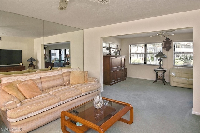 living room with carpet, a textured ceiling, and ceiling fan