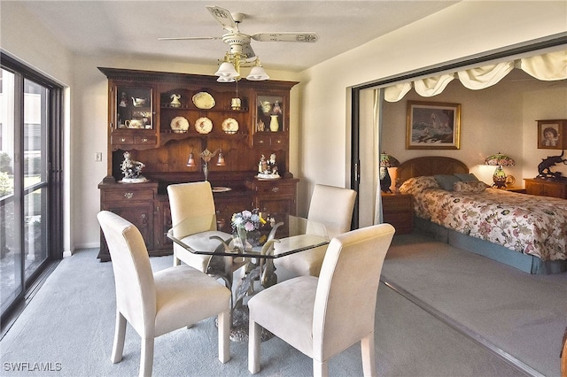 carpeted dining space featuring ceiling fan