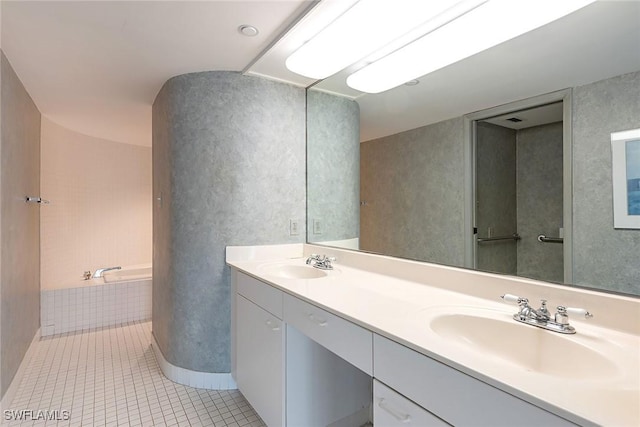 full bath featuring double vanity, tile patterned flooring, a sink, and a tub