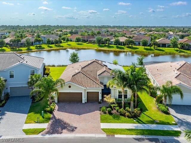 birds eye view of property with a water view