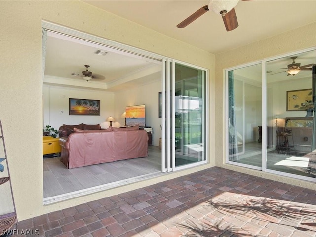 interior space featuring a ceiling fan, a raised ceiling, and visible vents