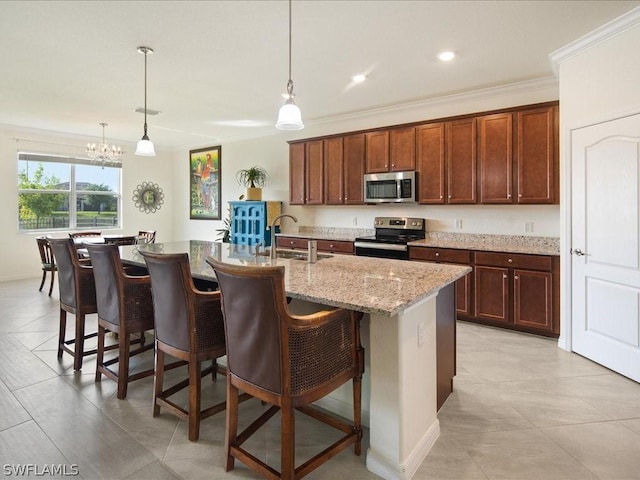 kitchen with appliances with stainless steel finishes, a sink, a breakfast bar, and crown molding