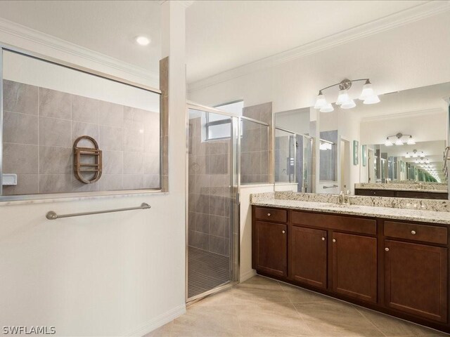 bathroom featuring vanity, crown molding, tile patterned flooring, and a shower with door