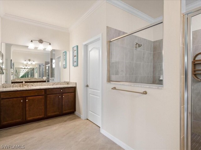 bathroom featuring ornamental molding, a shower with door, vanity, and tile patterned floors