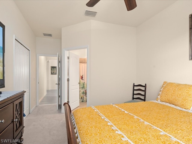 carpeted bedroom with ceiling fan and a closet