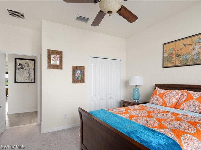 carpeted bedroom with ceiling fan and a closet