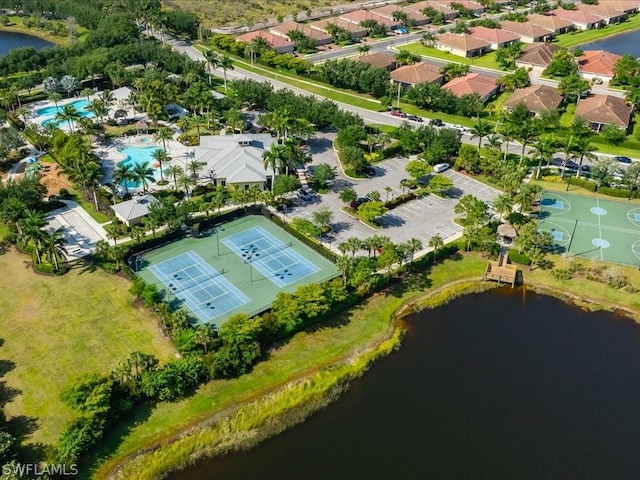 drone / aerial view with a water view and a residential view