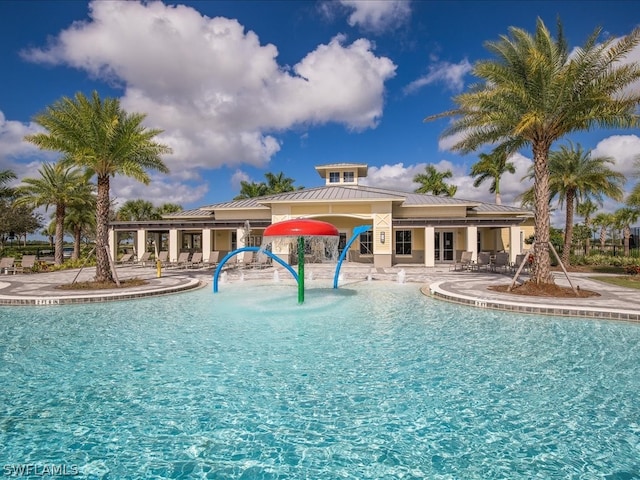 view of pool with pool water feature and a patio