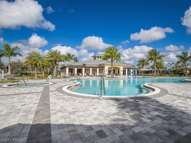 view of swimming pool with a community hot tub and a patio area