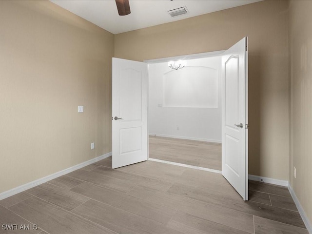 unfurnished bedroom featuring light wood-type flooring, visible vents, and baseboards