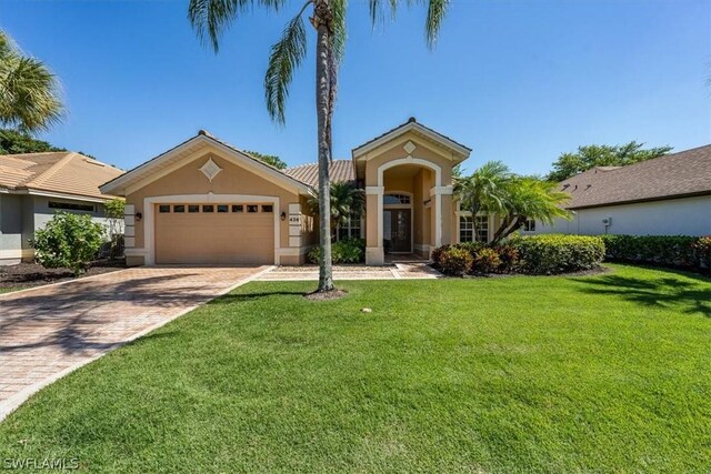 view of front of house with a garage and a front yard