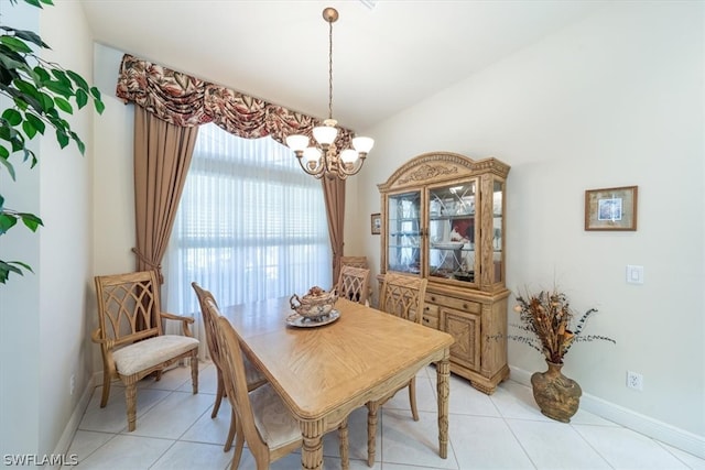 dining room with light tile patterned floors and a notable chandelier