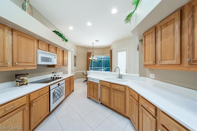 kitchen with hanging light fixtures, light tile patterned floors, white appliances, a chandelier, and sink