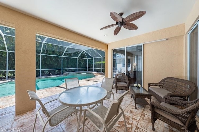 sunroom / solarium featuring ceiling fan and a pool