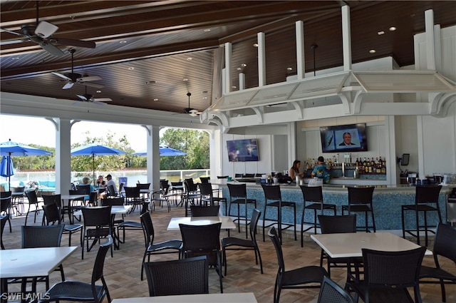 view of patio / terrace with ceiling fan and a bar