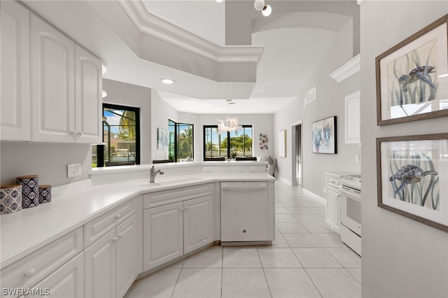 kitchen featuring white cabinets, sink, white appliances, and light tile flooring