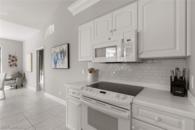 kitchen featuring white cabinets, white appliances, and backsplash