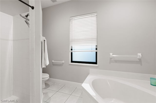 bathroom with a washtub, tile floors, toilet, and a wealth of natural light