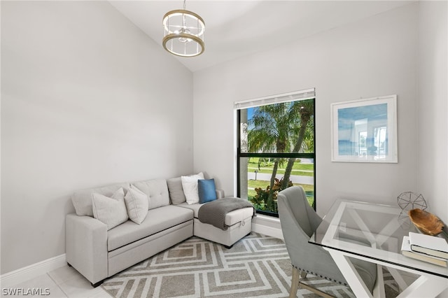 living room with an inviting chandelier, light tile floors, and vaulted ceiling