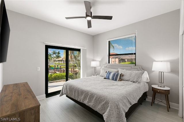 bedroom featuring light hardwood / wood-style floors, ceiling fan, and access to exterior