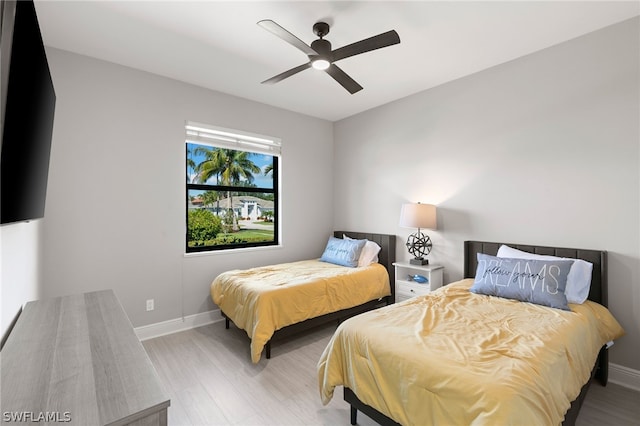 bedroom with light hardwood / wood-style flooring and ceiling fan